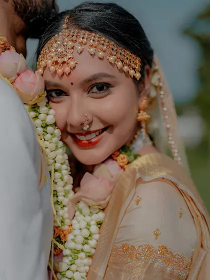 A close-up of the bride's joyful face. Her makeup is fresh and glowing, highlighting her natural beauty.