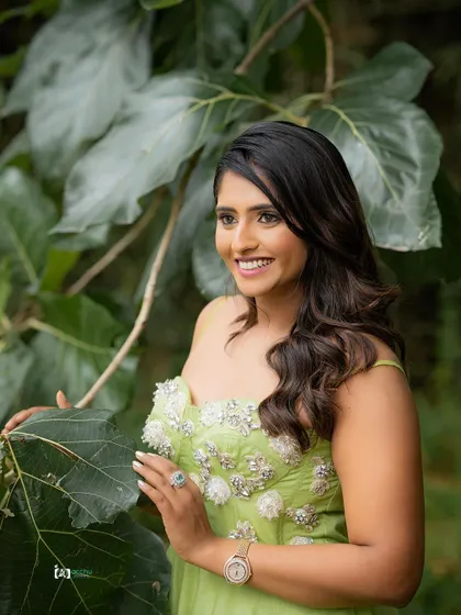 This shot captures a beautiful, candid smile. The natural environment provides a serene and organic backdrop for a relaxed portrait session.