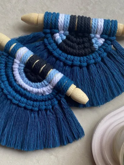 A detailed shot of two of our evil eye hangings, showing the consistent quality and craftsmanship. These make for a thoughtful and stylish housewarming gift.