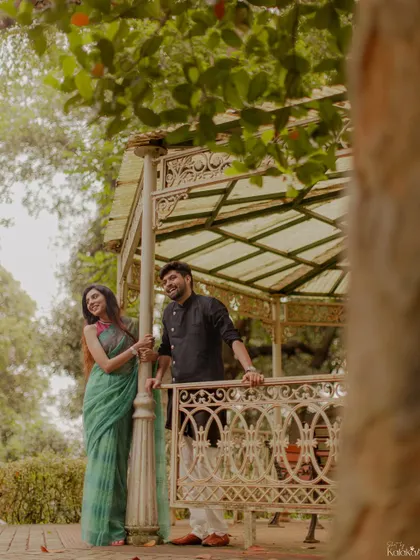 A happy, relaxed moment in a beautiful garden gazebo, capturing the couple's easy chemistry.
