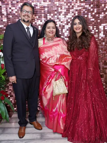 Another family portrait. The bride's red gown and classic makeup make for a timeless and beautiful reception look.