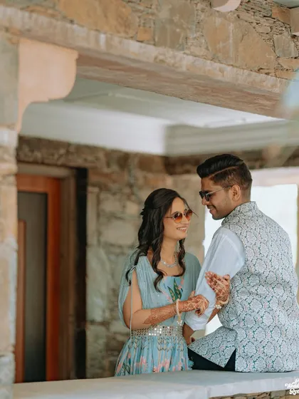 A sweet, candid moment between a young couple, their sunglasses adding a cool, relaxed vibe to the portrait.