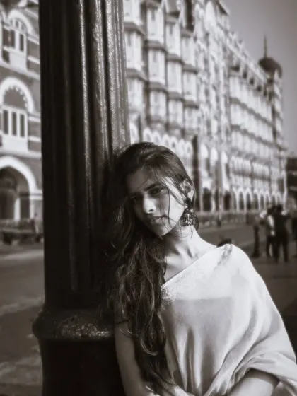 A classic black and white portrait in front of the Taj Mahal Palace Hotel, giving it a timeless, old-world charm.
