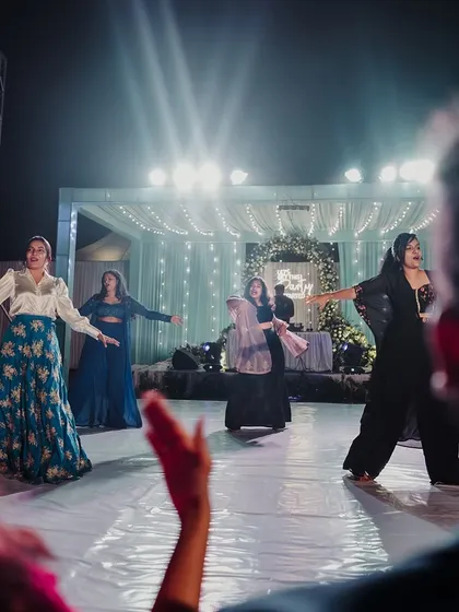 The party is in full swing on the custom dance floor. We ensured the stage and lighting were perfectly set up for performances and a night of dancing, with a beautifully decorated backdrop to complete the scene.