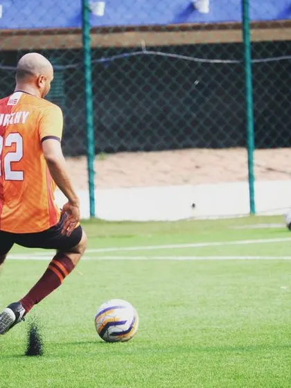 A player controlling the ball under pressure. Composure on the ball is a critical skill for playing at a high level.