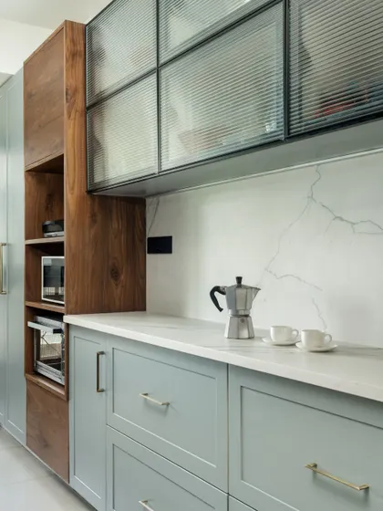 A detail of the kitchen counter, showing the mix of wood and painted finishes for a layered look.