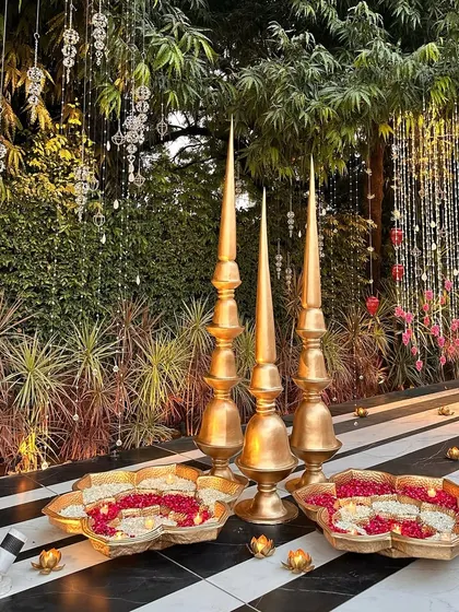Brass spires and floral urlis lining our black and white striped walkway.