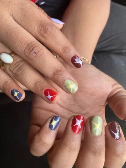 A playful set with retro starbursts on a mix of earthy tones like red, green, blue, and brown. Perfect for short, natural nails.