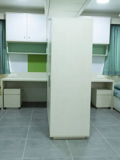 The interior of a student room at Vellore International School. The design is simple, functional, and provides each student with their own personal space.