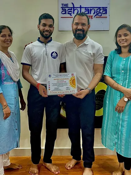 A student proudly receives his certificate from me. We celebrate every milestone on our students' path to becoming confident yoga professionals.
