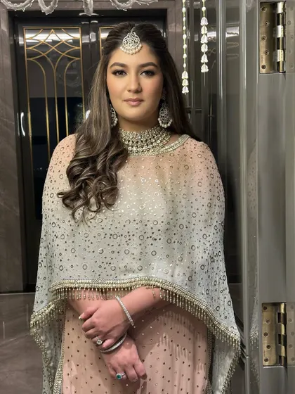 The full view of this elegant engagement look. The makeup is soft and glowing, perfectly complementing her beautiful Tarun Tahiliani outfit and creating a look of pure sophistication.