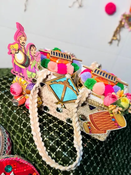 A unique Lohri gift idea. These mini purse-style bags are decorated with dhol and bhangra motifs, perfect for giving small treats or shagun.