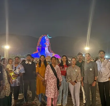The group in front of the magnificent Adiyogi statue at night. The light show is a spectacular sight to behold.