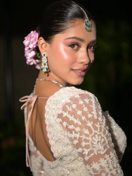 Another beautiful portrait of the bride. The makeup is subtle and enhances her natural beauty, while the flowers add a touch of romance.
