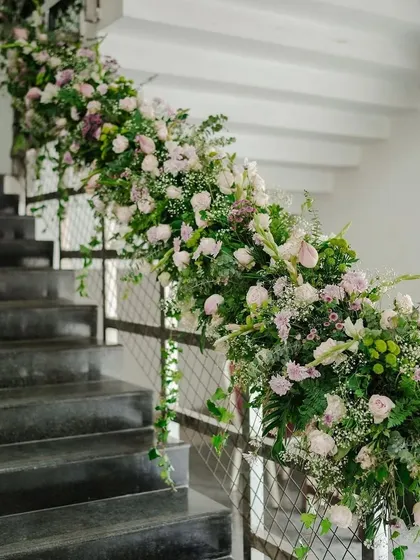 A beautiful floral arrangement cascading down a staircase railing, transforming a simple space into something special.