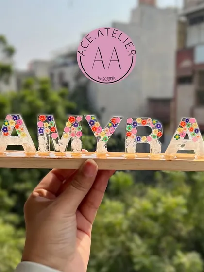 Another beautiful custom name stand, this one for Amyra. The clear resin letters filled with multicolored flowers create a bright and cheerful personalized gift.