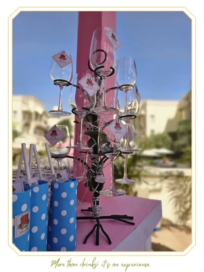 A display of custom props, including a unique glass tree and personalized gift bags, showcasing how we can extend the bar theme to other event elements.