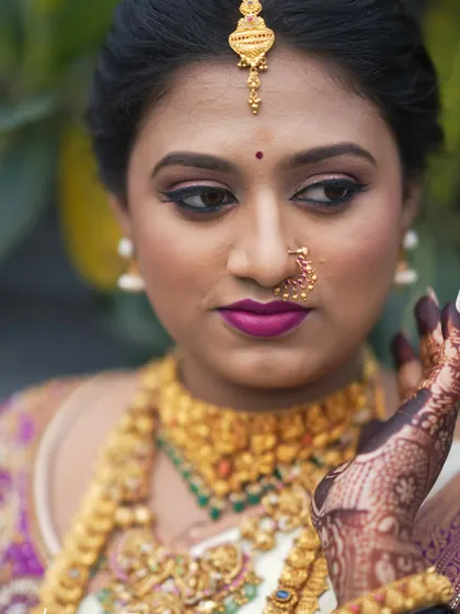 A detailed shot focusing on the eye makeup and flawless skin finish for bride Pooja. The defined liner and soft eyeshadow make her eyes stand out beautifully.