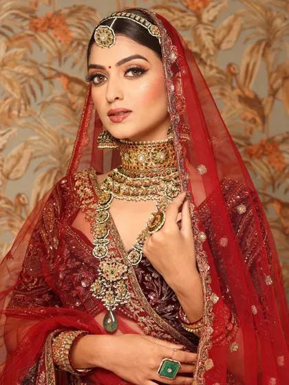 A close-up of the bride, her kohl-defined eyes and rich jewelry creating a powerful, royal statement.
