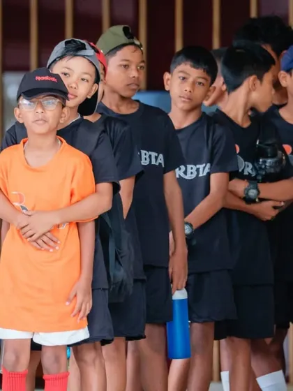 A group of our young, aspiring players, focused and ready for their next drill. We aim to build not just tennis skills, but also character, teamwork, and the mental fortitude of a champion.