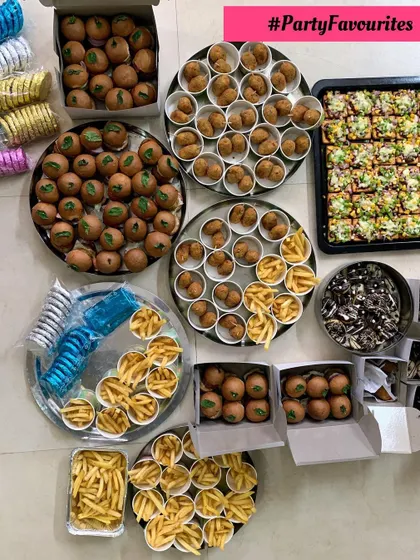 Party favorites including mini burgers, fries, cheese balls, and pizza crackers.