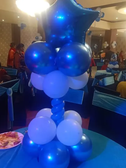 I also provide themed table centerpieces, like this one for a Boss Baby party. These small details help tie the whole party's theme together.