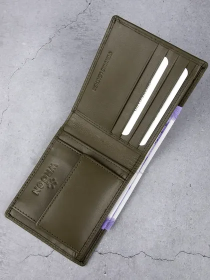 An overhead shot of the open olive green wallet.