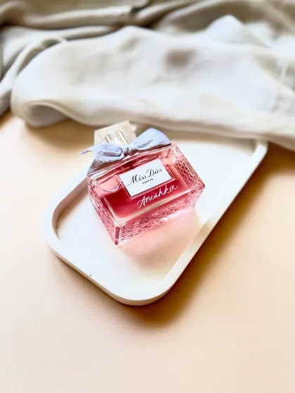A timeless Miss Dior perfume bottle, made unforgettable with a hand-engraved name. The delicate script adds a layer of personal elegance to this iconic fragrance.