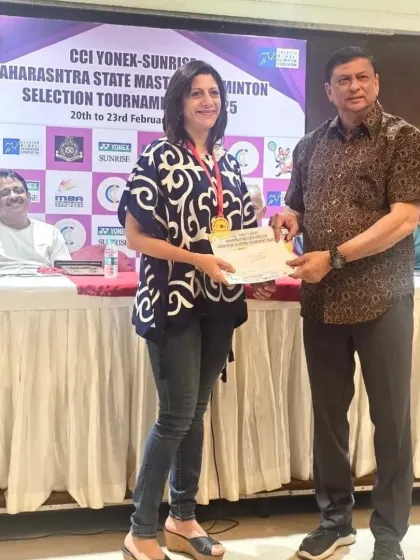 Naheed Divecha receiving one of her three awards at the Maharashtra State Masters Championship from a senior official.