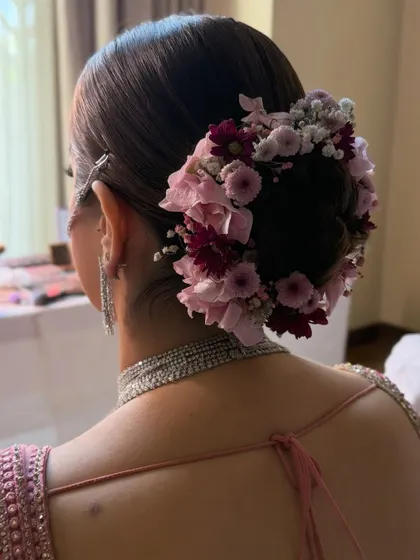 Another angle of the pink and burgundy floral bun, highlighting the texture and volume of the updo.