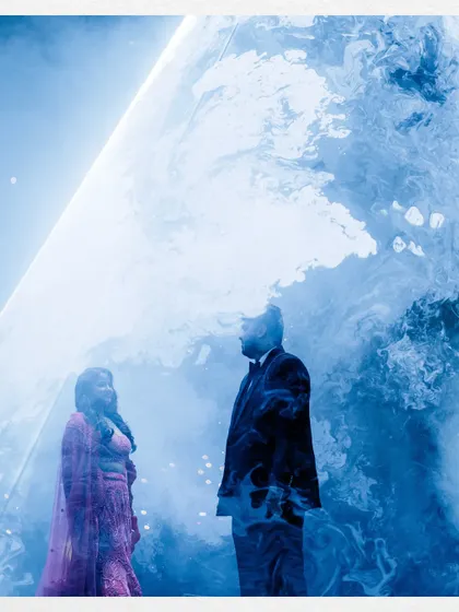 A creative double-exposure style portrait of the couple, blending their silhouettes with a dreamy, cloud-like texture.