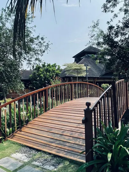 Even small details matter in creating an experience. This simple wooden bridge at the Gokulam resort is more than a path; it's a transition point that slows the pace and connects guests with the natural water elements central to the design.