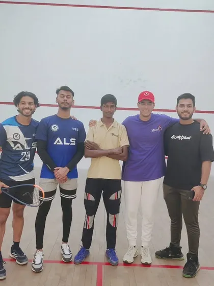 A group of smiling participants at the Amity University squash tournament. Fostering camaraderie is a key part of our events.