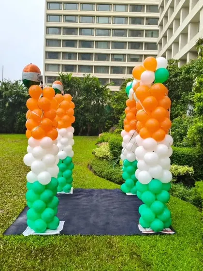 Balloon pillars in saffron, white, and green, creating a walkway for an Independence Day or Republic Day event.