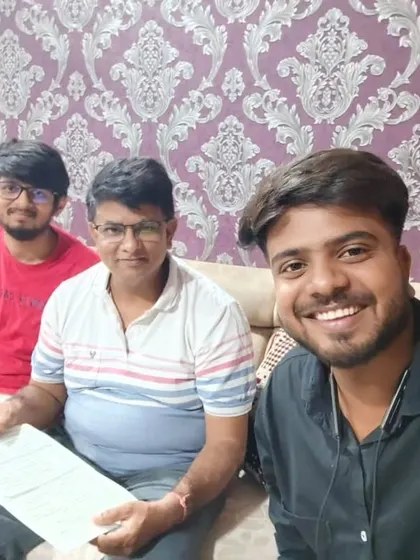 Our team takes a selfie with a family holding their new solar agreement.