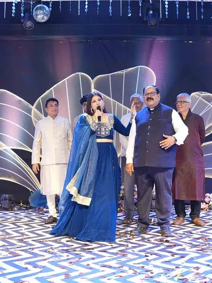 Interacting with the family patriarchs on stage, making them the stars of the show for a moment.