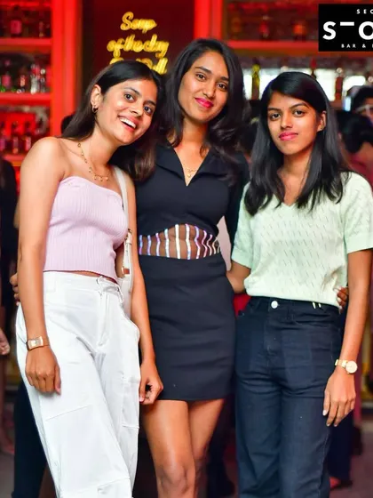 A duplicate of the three friends at the bar. It's a stylish and happy snapshot.