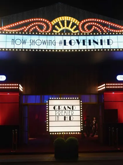 No venue? No problem. For this Sangeet in Vietnam, we built a full-scale party theatre from scratch, complete with a classic cinema marquee to welcome guests to the 'Grand Premier'.