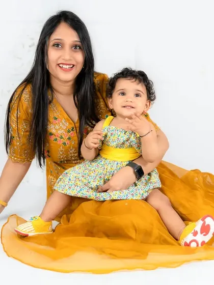 A close-up of a mother and her daughter, both smiling brightly. This shot perfectly captures their joyful connection.
