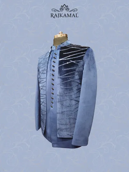 A side angle of the blue velvet jacket, showing the depth of the color and the sparkle of the sequin work.