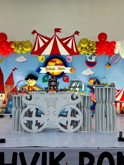 A close-up of the cake table on the red and white carnival stage, designed to look like a royal carriage.