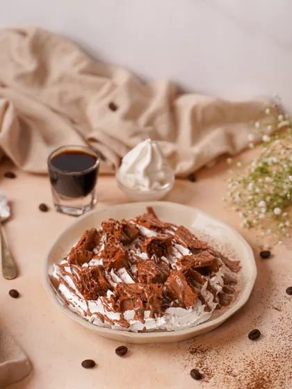 A messy, delicious dessert plate with chocolate, cream, and coffee elements. This styled shot captures the feeling of a rich, deconstructed tiramisu.