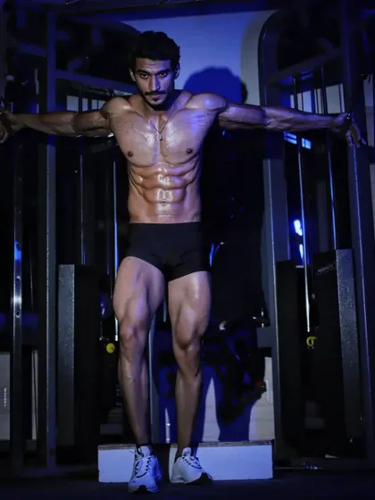 A crucifix pose, highlighting chest, shoulder, and arm development. This is a powerful pose that demonstrates both size and conditioning.