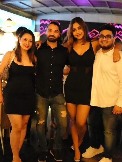 Posing with a group of friends, celebrating a fun night out.