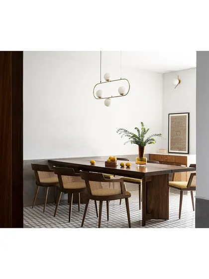 Another angle of the dining space, highlighting the elegant chairs and the long wooden table.