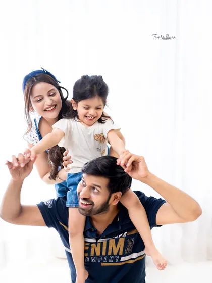Pure fun and laughter! A playful shot with dad giving his daughter a shoulder ride shows the joyful, candid side of family photography.