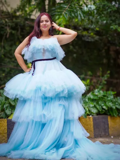 A full-length shot of the sky blue ruffle gown, highlighting its magnificent trail and voluminous skirt.