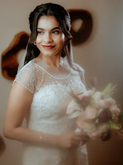 A soft-focus shot of a bride in her white wedding gown, creating a dreamy and romantic atmosphere.