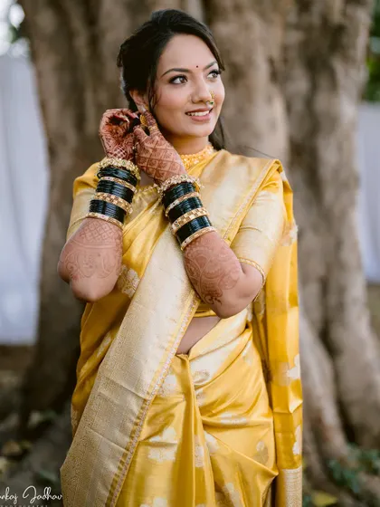 A happy bride adjusting her earrings, a classic and beautiful getting-ready shot.