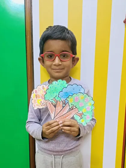 A proud student with his completed seasons artwork.